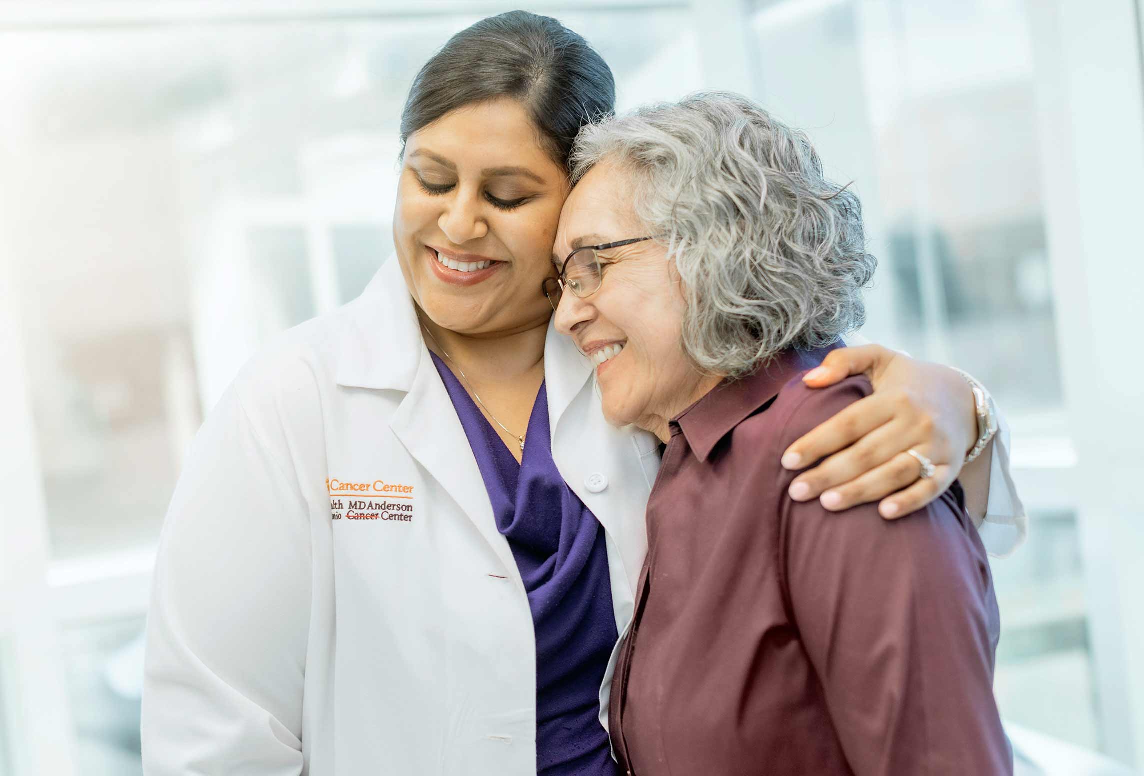 UT Health San Antonio MD Anderson Cancer Center doctor hugs a patient