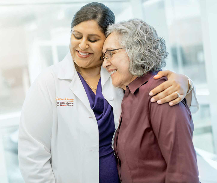 Doctor hugging patient