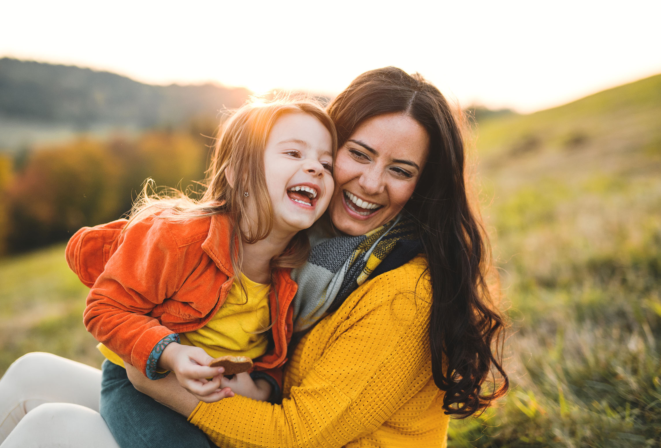 mom and daughter laughing outside