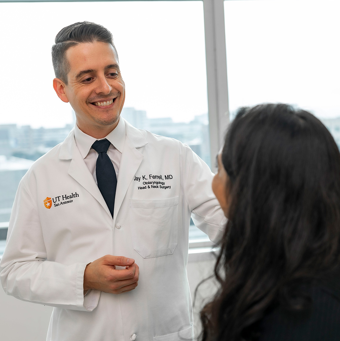 A photo of Dr. Jay Ferrell with a patient