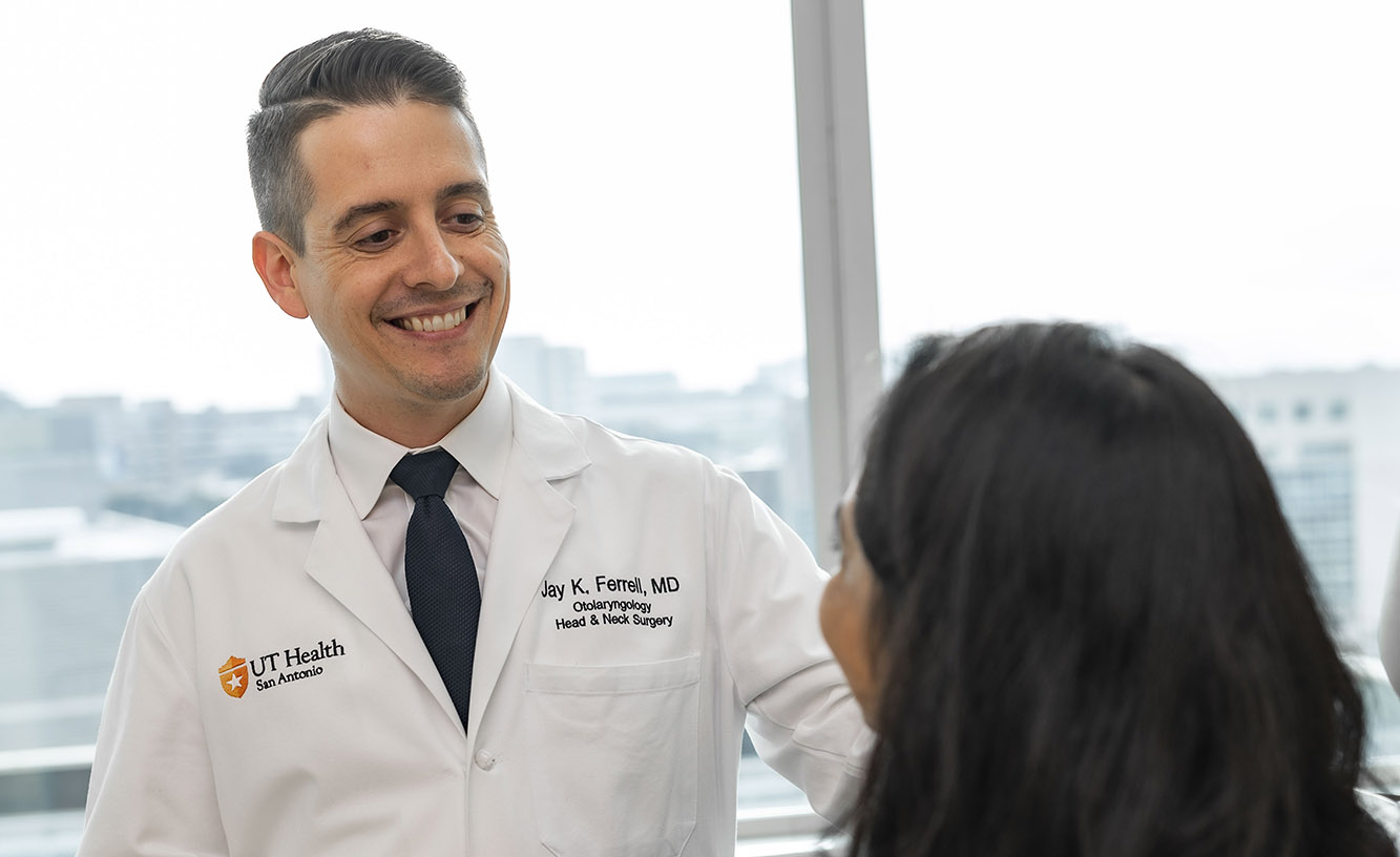 A photo of Dr. Jay Ferrell with a patient