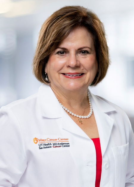 A headshot of Dr. Amelie Ramirez in her white coat