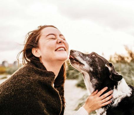 woman and dog embracing