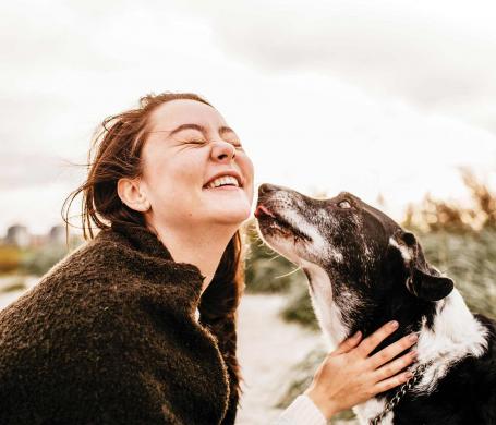 woman and dog embracing