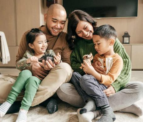 Photo of family embracing each other at their home